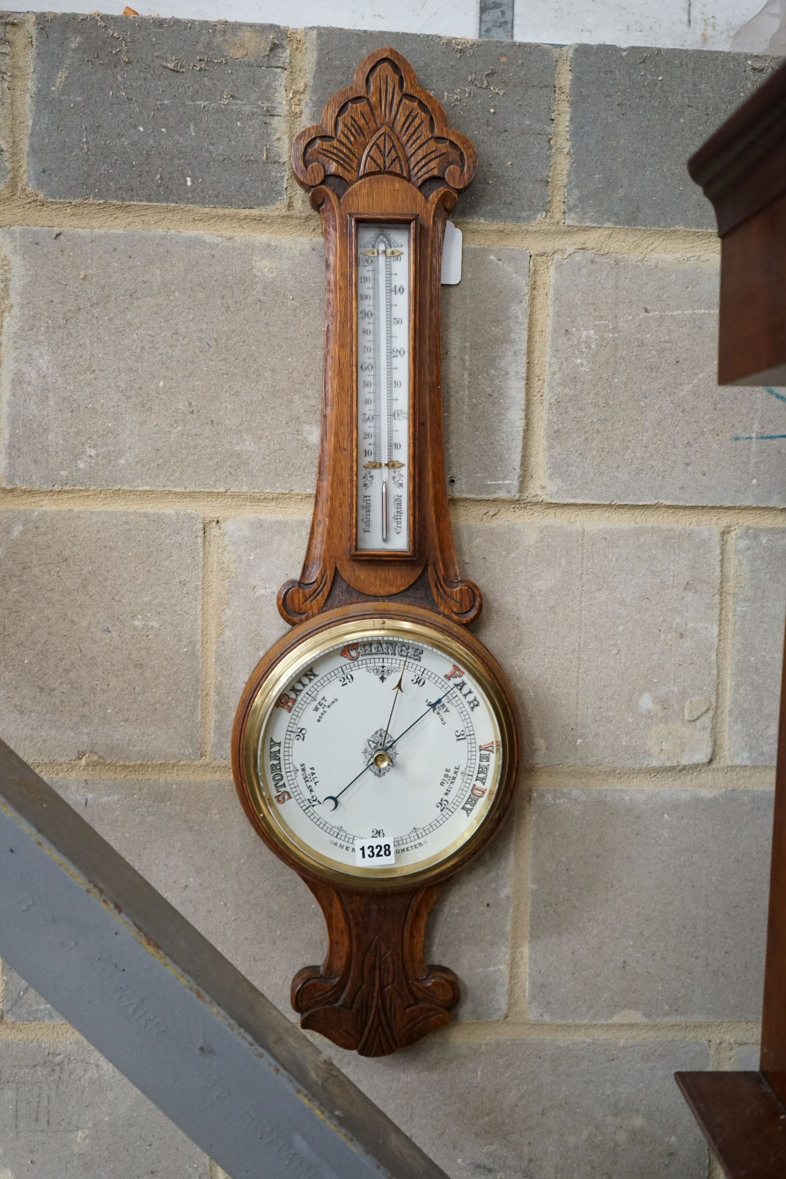 A late Victorian carved oak aneroid barometer and thermometer, height 84cm